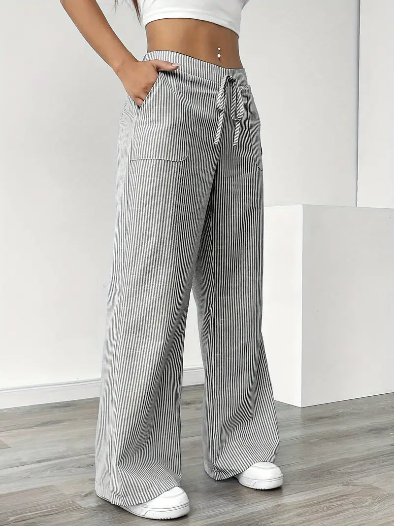 Women's striped wide-leg pants with pockets, accessorized with a belt for a chic touch.