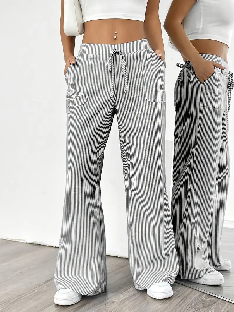 Chic women's striped pants with pockets, high-waist design for flattering spring fashion.
