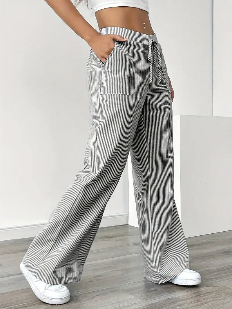Fashionable striped ladies trousers, high-waist and wide-leg with useful pockets for style.