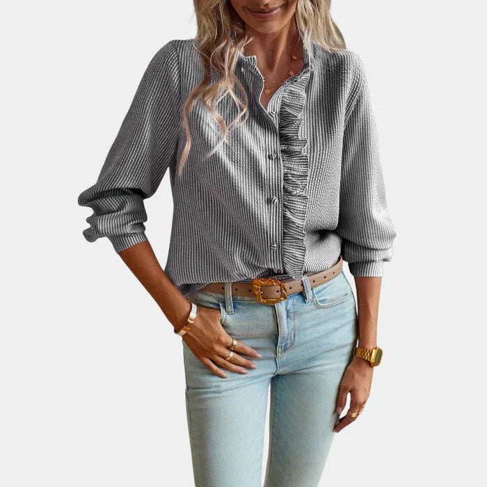 Stylish women's button-down striped blouse with ruffles, ideal for spring fashion or office wear.