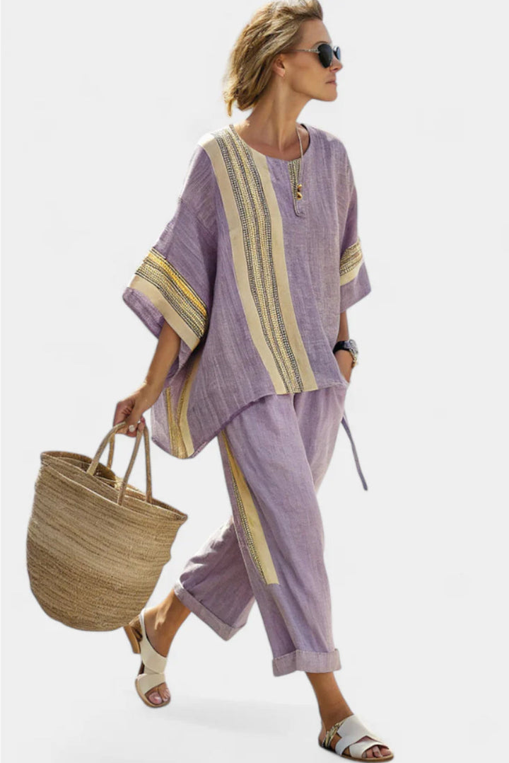 Chic women's two-piece set: striped top and wide-leg pants, ideal for elegant outfits & travel-friendly fashion.