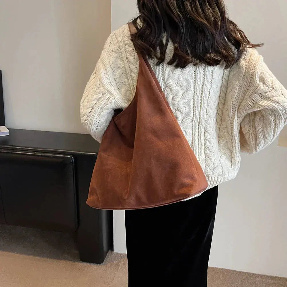 Close-up of the luxurious suede texture on this versatile women's shoulder bag.