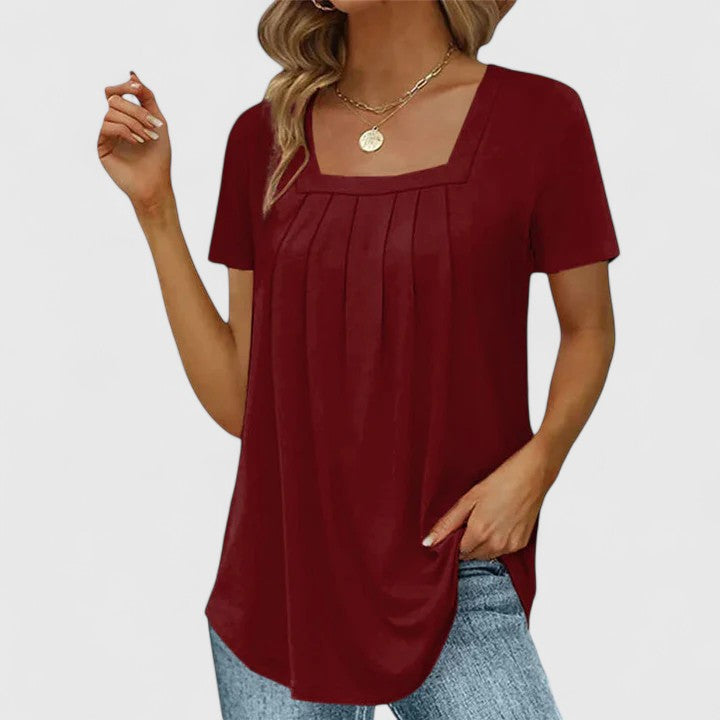 Fashionable women's summer blouse featuring an elegant square neck and short sleeves for sophisticated warm-weather wear.