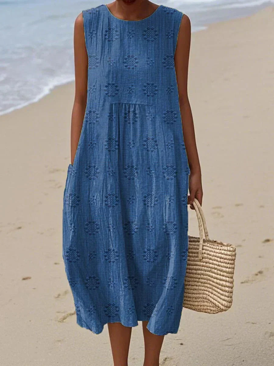 Close-up of the stylish pockets on an embroidered women's summer midi dress. Versatile and flattering.