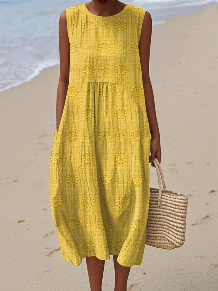 Woman enjoying a summer day in a comfortable and elegant sleeveless midi dress with functional pockets.