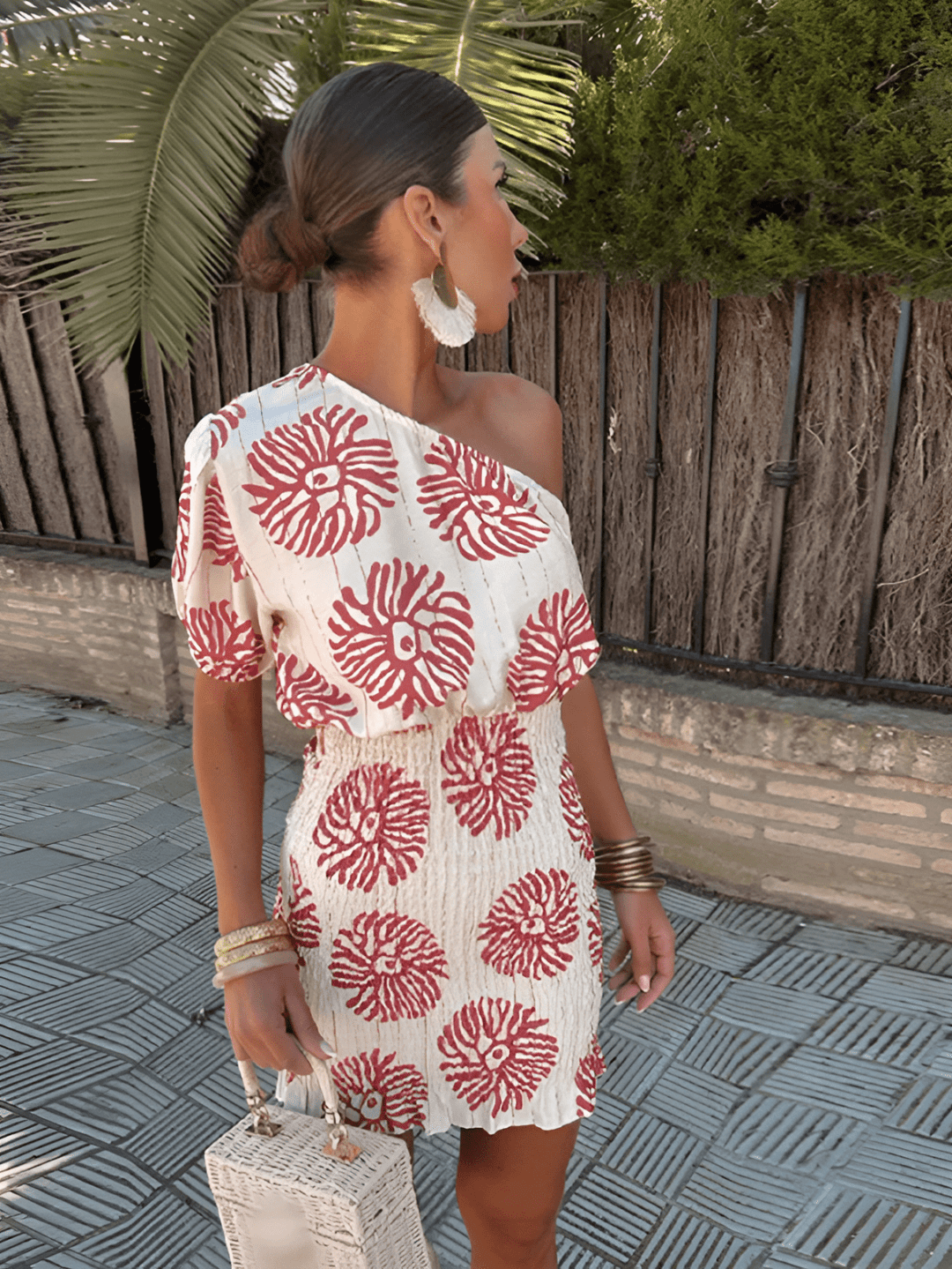 Elegant women's summer mini dress with bold floral print. One-shoulder design, perfect for beach, party, or vacation.