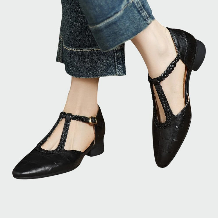Classic black T-Bar Mary Jane shoes for women, featuring a stylish pointed toe and stable block heel. Vintage elegance.
