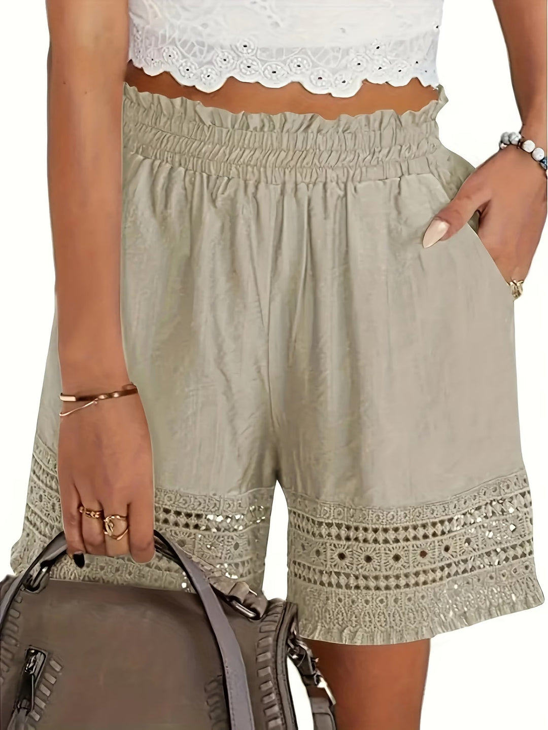 Elegant women's tailored shorts with delicate lace trim, slant pockets, perfect for chic summer daywear or evening.