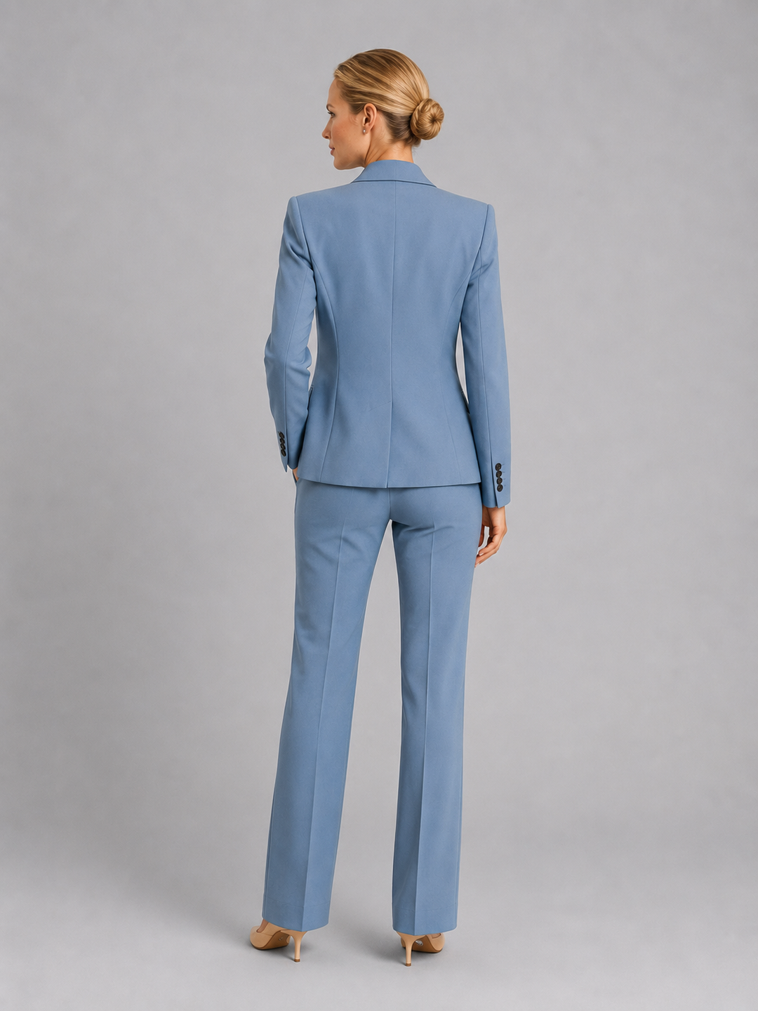 Model in elegant women's tailored trouser suit, a chic two-piece blazer set for weddings, business & formal events.