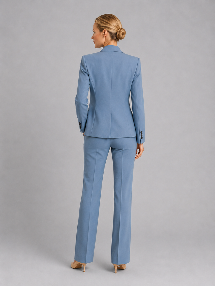 Model in elegant women's tailored trouser suit, a chic two-piece blazer set for weddings, business & formal events.