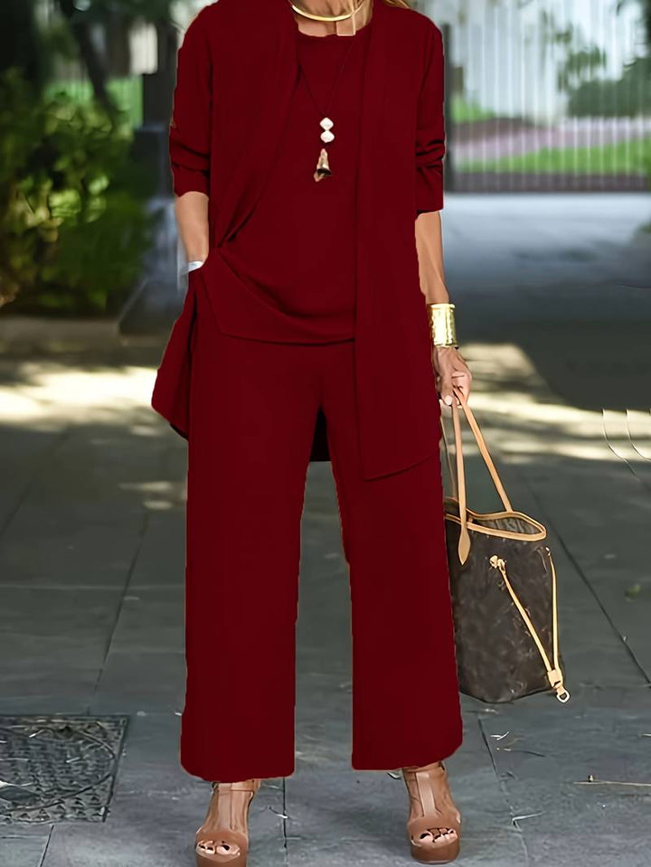 Elegant women's three-piece pantsuit. Sophisticated long sleeve, round neck top, trousers & jacket for versatile wear.