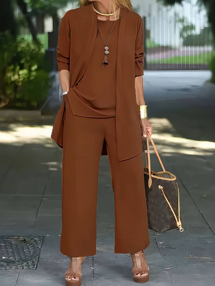 Stylish women's three-piece pantsuit. Elegant long sleeve top, comfortable trousers & sophisticated jacket for any occasion.