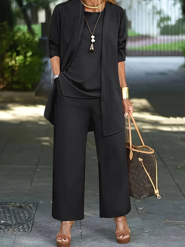 Modern women's three-piece pantsuit. Business attire meets casual chic with this sophisticated long sleeve top, pants & jacket.