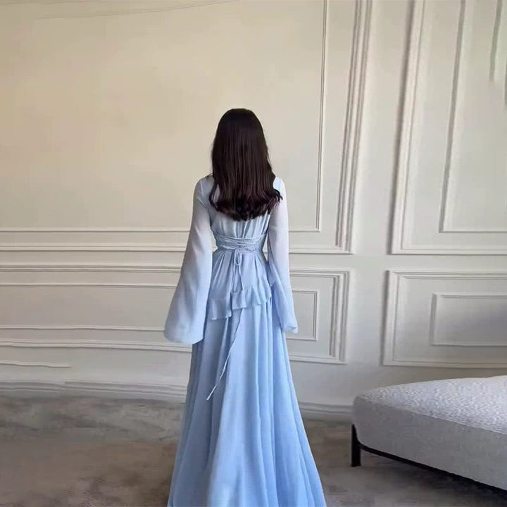 Stunning tiered maxi dress for women, featuring elegant bell sleeves, ideal for wedding guest attire.
