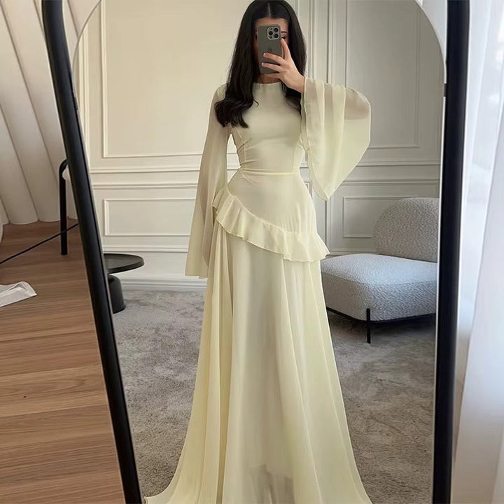 Formal women's wedding guest maxi dress with flowing tiered skirt & stylish bell sleeves.