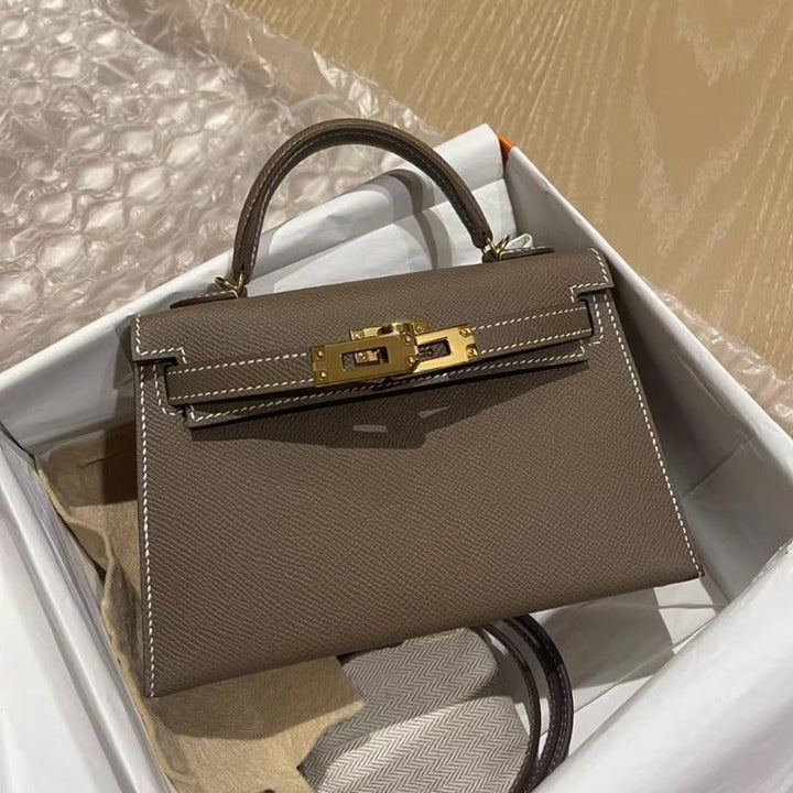 Versatile women's top handle handbag with an elegant gold lock, suitable for both formal and casual settings.