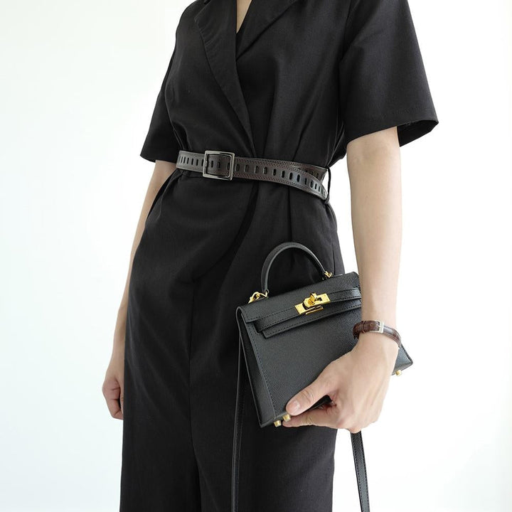 Women's day-to-evening top handle handbag, featuring a structured shape and an ornate gold lock.