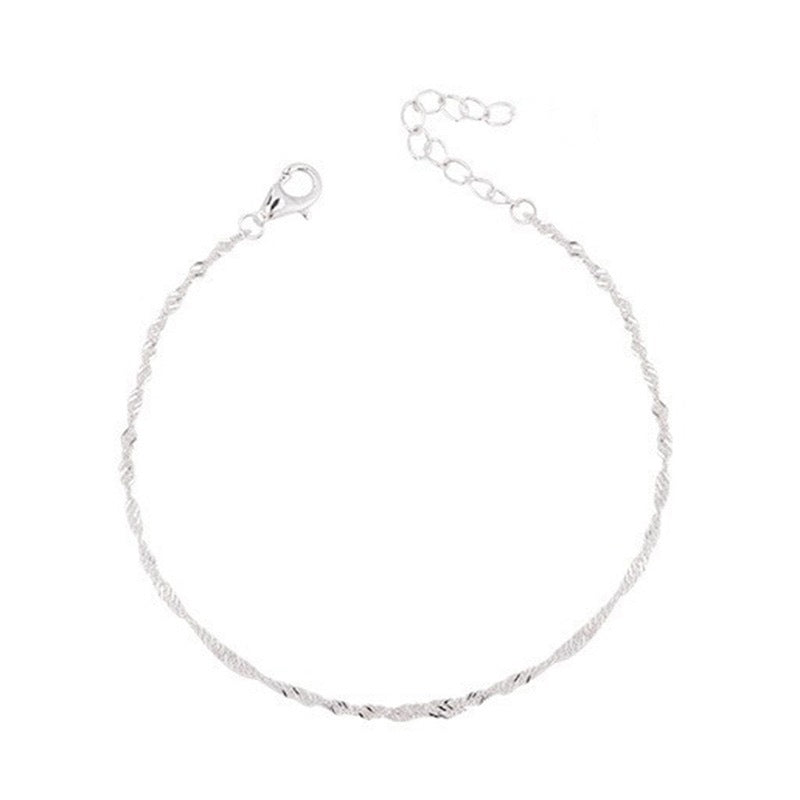 Stacked with other gold jewelry, an elegant women's twisted chain bracelet for a trendy look.