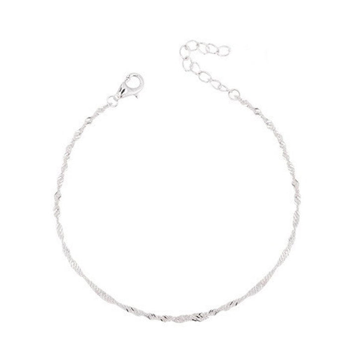 Stacked with other gold jewelry, an elegant women's twisted chain bracelet for a trendy look.
