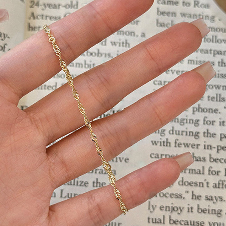 Women's dainty elegant gold twisted chain bracelet, adjustable for a perfect fit, a timeless accessory.