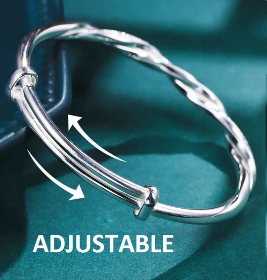 Adjustable silver twisted cuff bracelet for women. Chic minimalist design, ideal for everyday wear or special occasions.