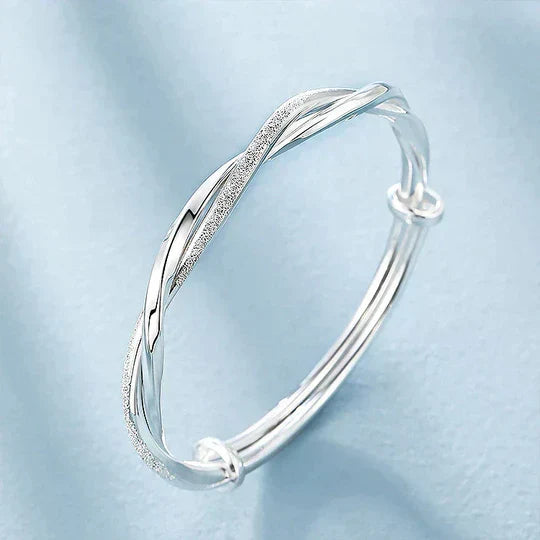 New women's fashion twisted silver cuff bracelet. Elegant and adjustable, a perfect gift for her, enhances any outfit.