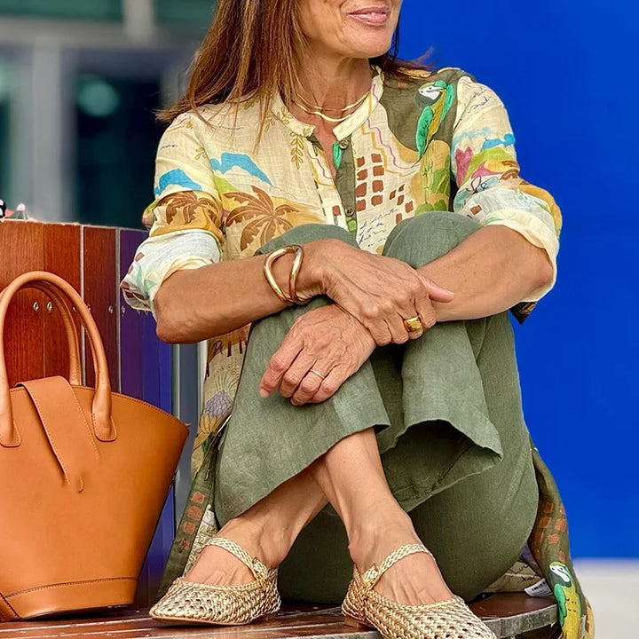 Woman modeling a casual chic women's two-piece set with a printed top and wide-leg trousers, ideal for elegant fashion.