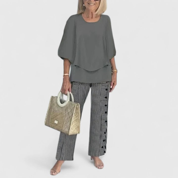 Model in elegant women's two-piece set, a sophisticated choice for formal summer occasions. Comfortable fashion.