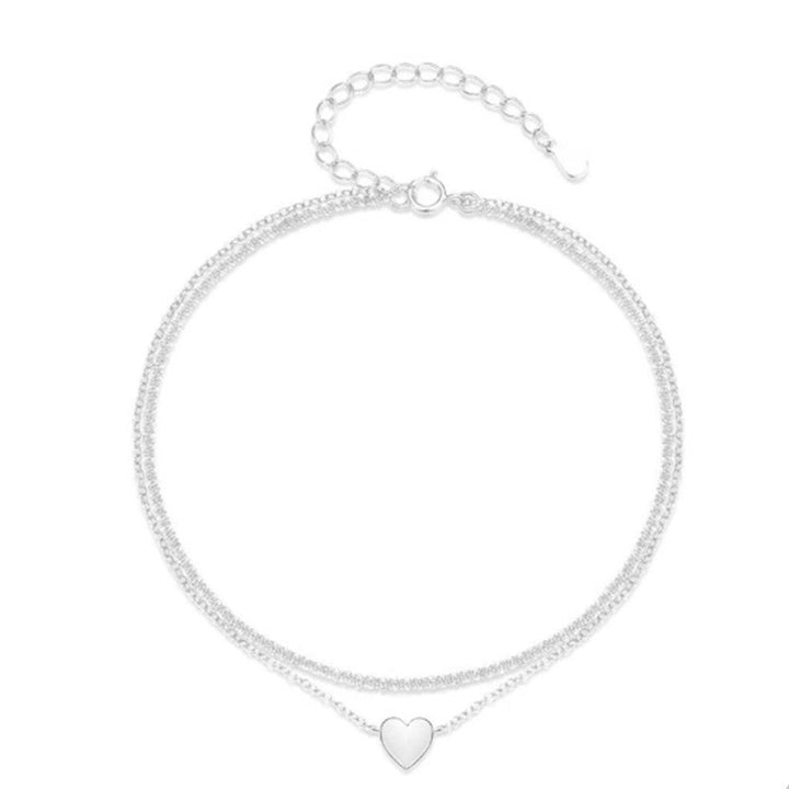 Women's two-tone heart charm anklet, an elegant silver & gold dainty ankle bracelet, perfect summer jewelry.