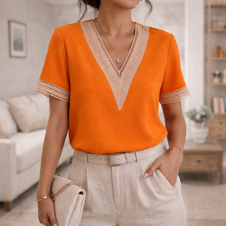 Women's elegant V-neck blouse with lace trim & short sleeves. Seamlessly transitions from office to weekend wear.