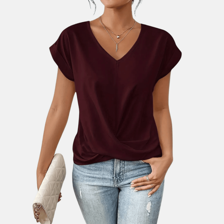 Casual women's V-neck top, perfect for spring. Features a comfortable relaxed fit and stylish draped hem.