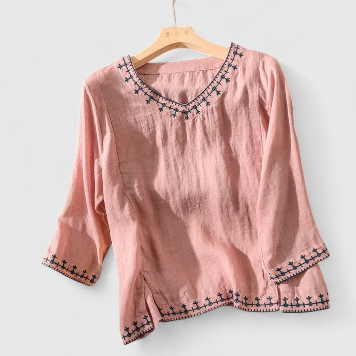 Relaxed fit V-neck blouse for women, featuring elegant embroidery, suitable for everyday or office.