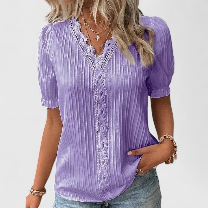 Stylish women's V-neck top with delicate hollow short sleeves, ideal for versatile casual to elegant summer outfits.
