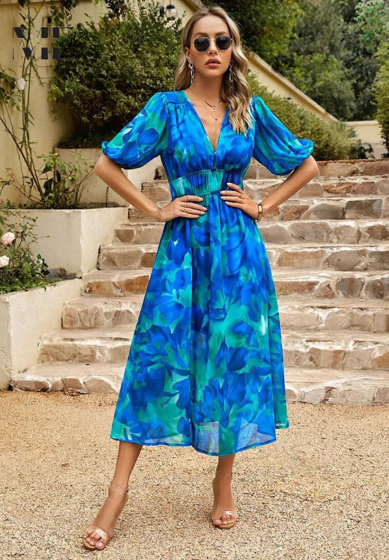Zoomed-in view of the empire waist and short sleeves on a women's floral A-line midi summer dress.