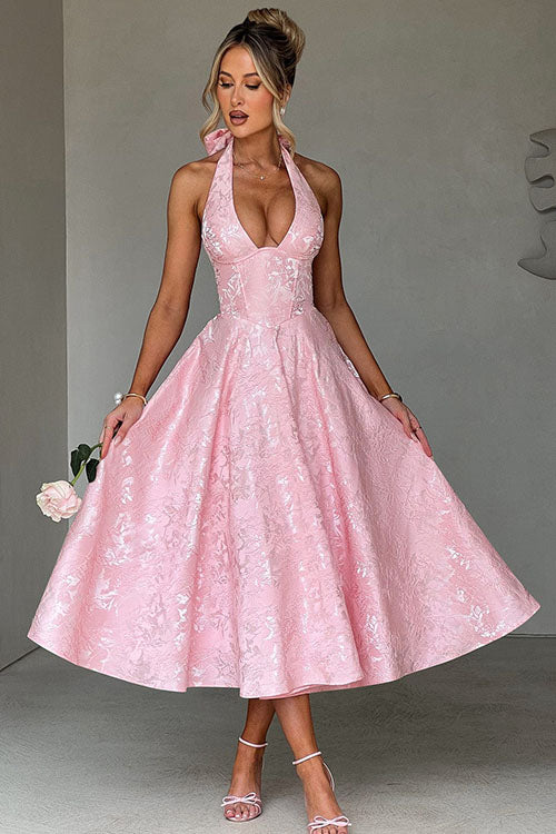 Back view of women's V-neck halter maxi dress, showing open back design.