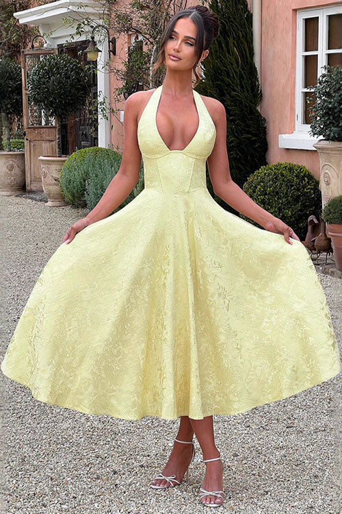 Woman in elegant V-neck halter jacquard maxi dress, perfect for evenings.