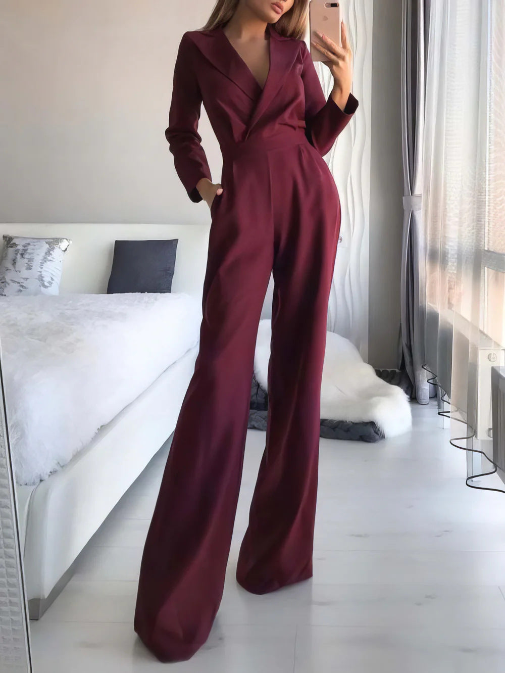 Modern women's long sleeve V-neck jumpsuit featuring a flowing wide-leg design for a sophisticated look.