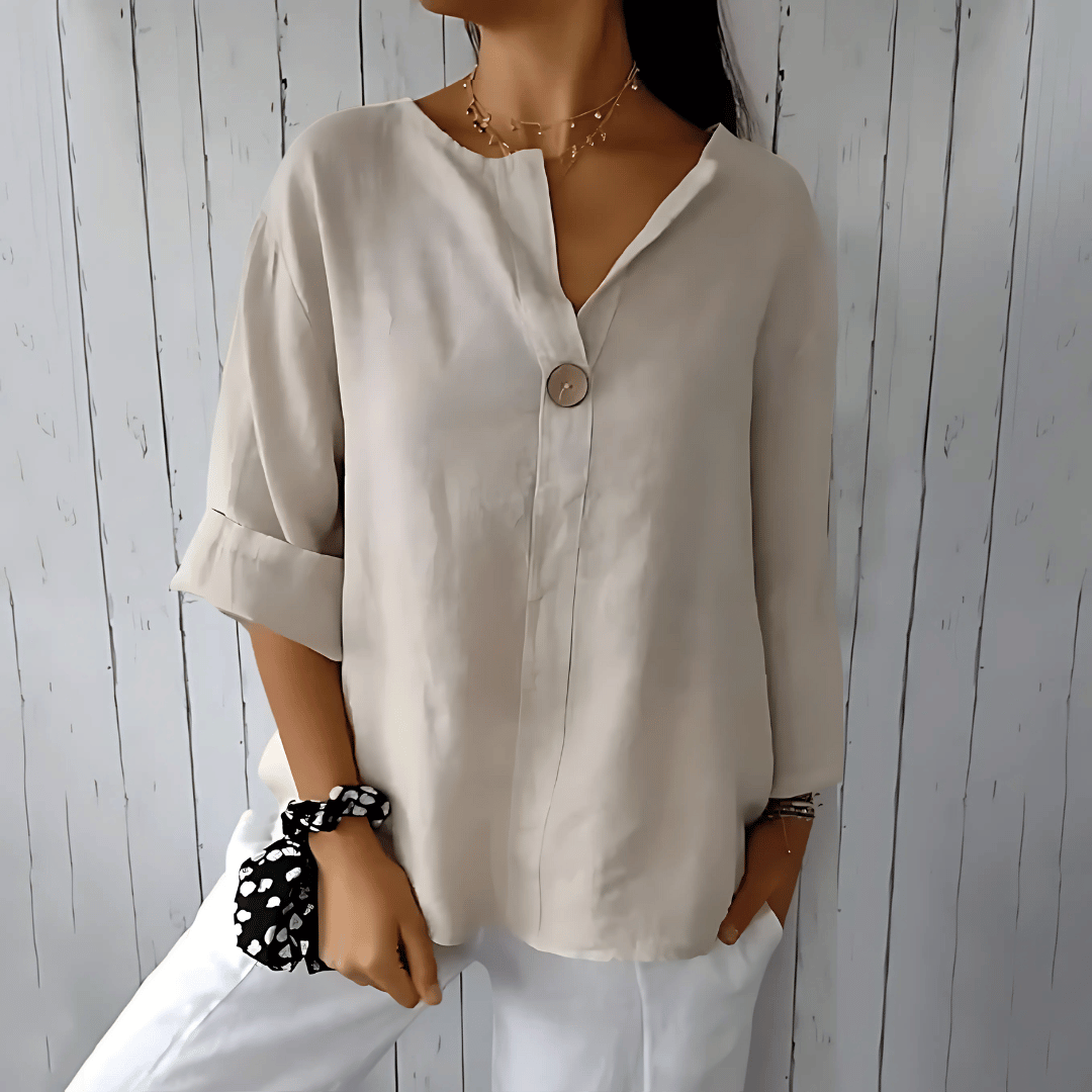 Fashionable women's loose V-neck blouse, ideal summer top with 3/4 sleeves for comfort & office chic. Plus size available.
