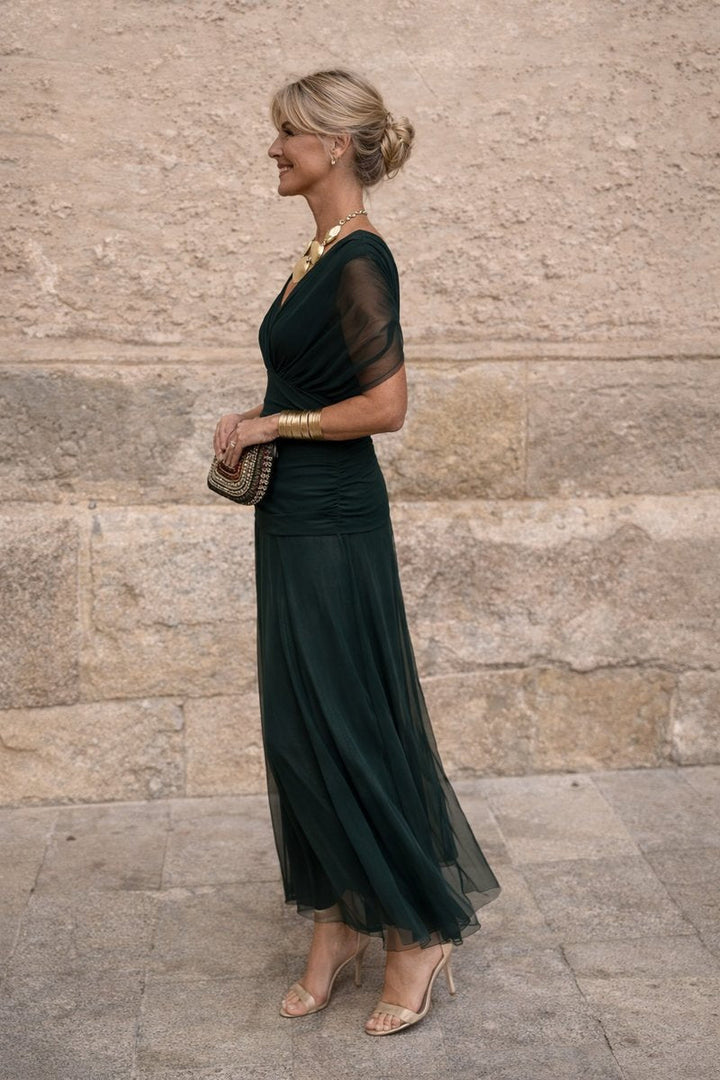 Chic long formal evening gown for women, featuring a flattering V-neck and elegant pleated waist detail.