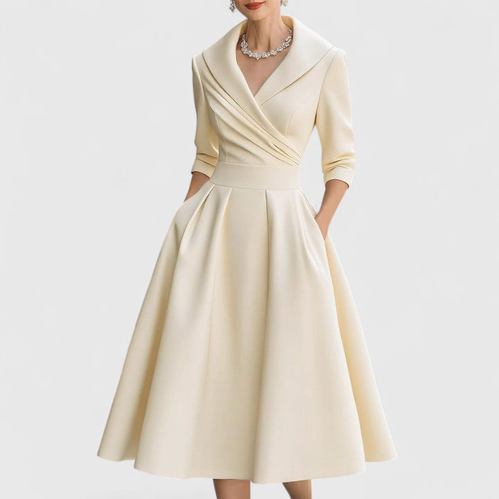 Stylish women's V-neck midi dress with elegant 3/4 sleeves, showcasing its flattering flared skirt design.