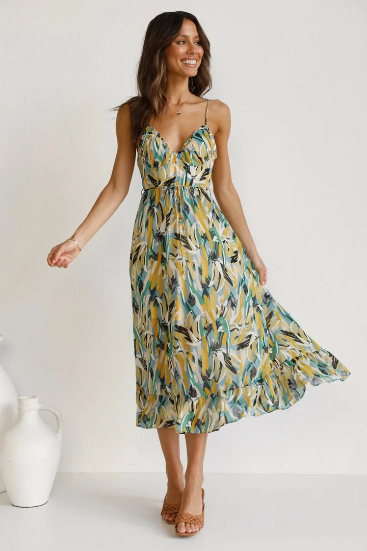 Stylish bohemian midi dress for women, perfect for beach vacations. Features a V-neck and delicate spaghetti straps.
