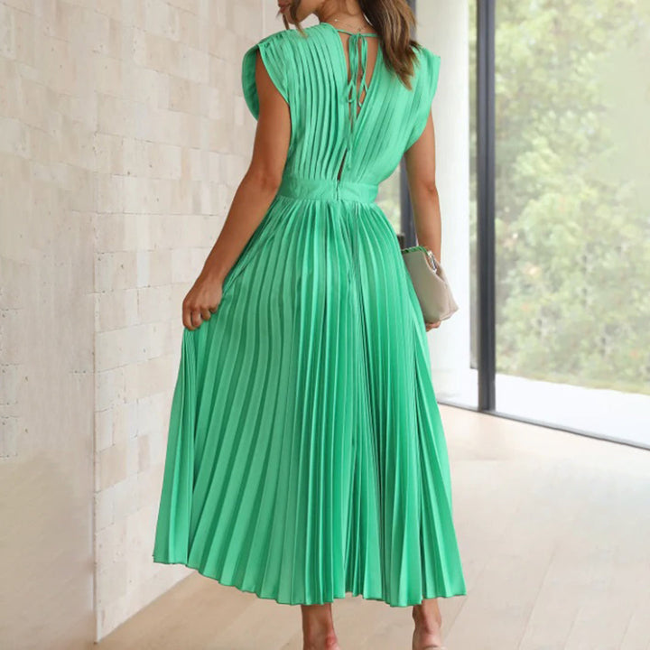 Long, flowy V-neck pleated maxi dress for women, an elegant & sophisticated wedding guest outfit.