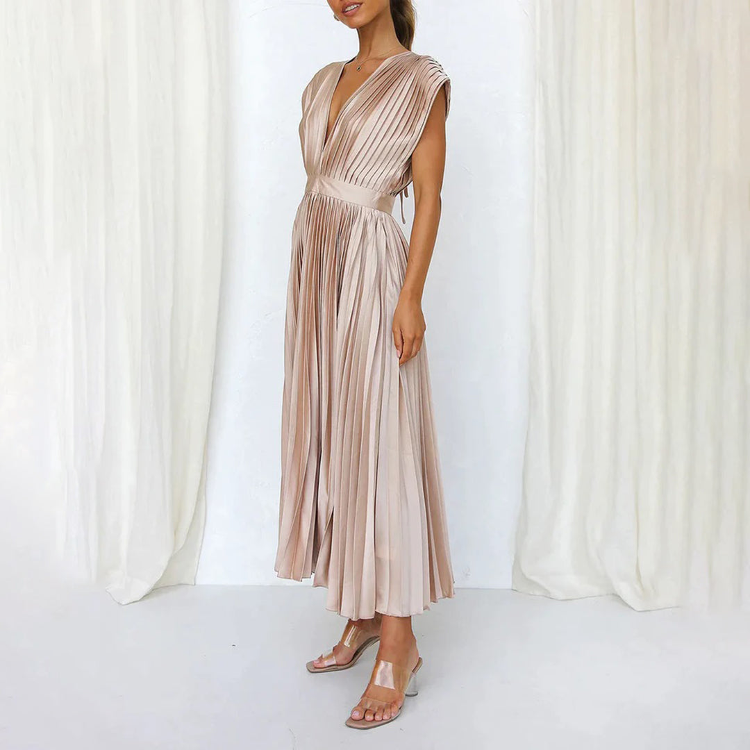 Flowy pleated maxi dress with V-neck, ideal evening gown or wedding guest attire for women.