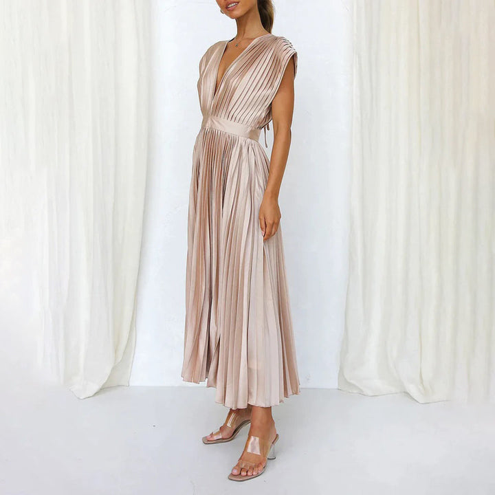 Flowy pleated maxi dress with V-neck, ideal evening gown or wedding guest attire for women.