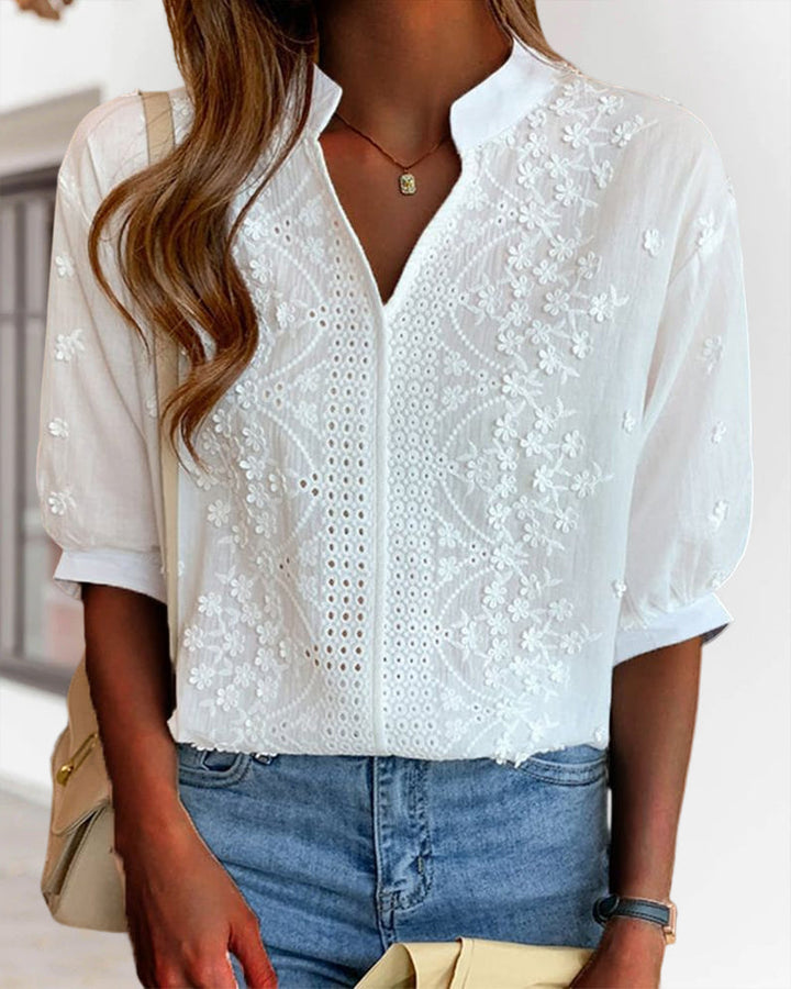 Women's elegant summer blouse: V-neck, puff sleeves, and embroidered details for a casual chic look.