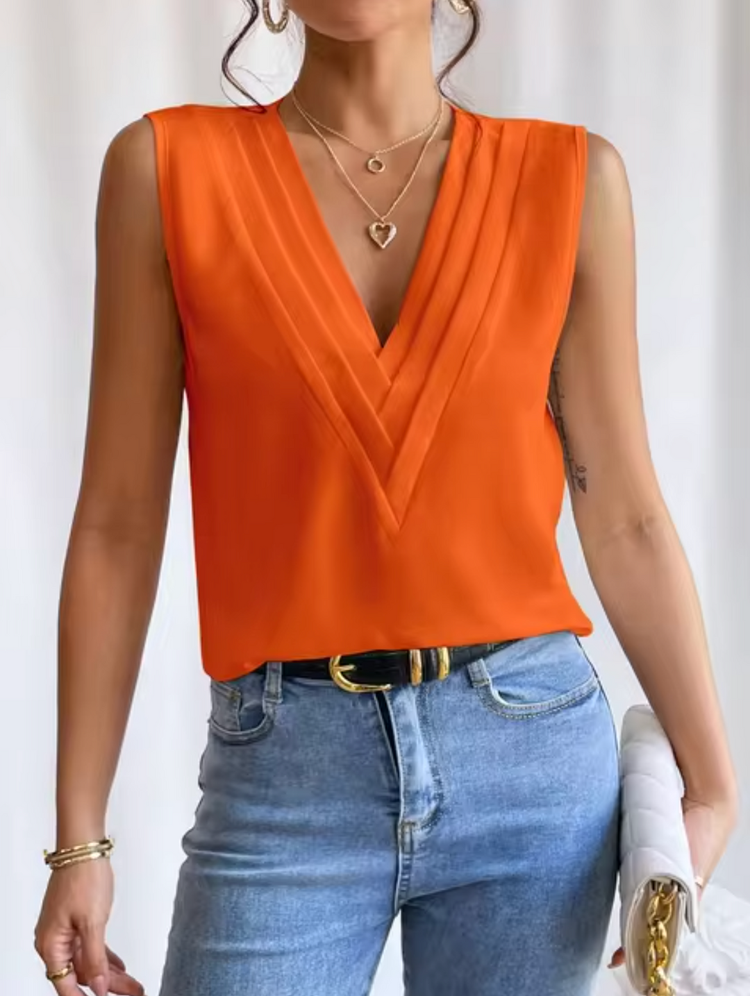 Stylish women's V-neck sleeveless top, ideal for casual summer wear or elegant spring fashion outfits.