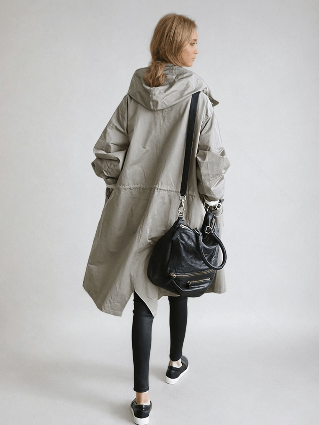 Water-repellent women's trench coat, keeping you dry & stylish in all seasons. Essential elegant outerwear.