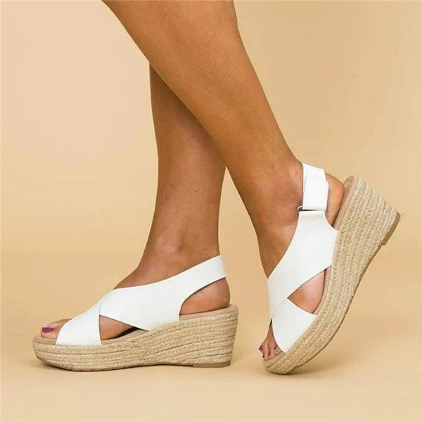 Women's elegant wedge sandals with a comfortable footbed and adjustable ankle strap, great for summer.