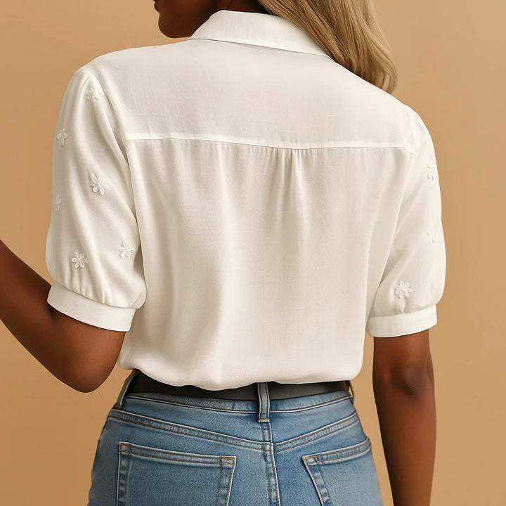 Stylish new women's white embroidered blouse with a stand collar, offering an elegant and versatile fashion statement.