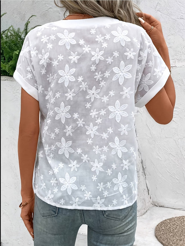 White women's elegant floral button-up shirt. Timeless long sleeve top for casual or dressed up spring outfits.